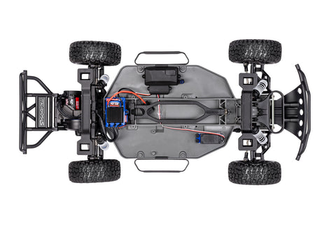 Overhead view of Traxxas Slash 2WD BL-2s RC truck chassis, showing detailed black and red components and suspension parts.