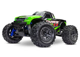 Green Traxxas Stampede 4X4 BL-2s electric monster truck on a dirt track, showcasing its rugged design and off-road tires.