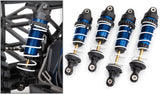 Blue anodized Traxxas Slash 4X4 VXL Ultimate RC truck with GTR shocks, showcasing its performance-ready suspension system.