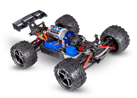 Traxxas 1/16 E-Revo 4X4 RC truck with chassis and USB-C port, detailed view of the remote-controlled vehicle's side and front.