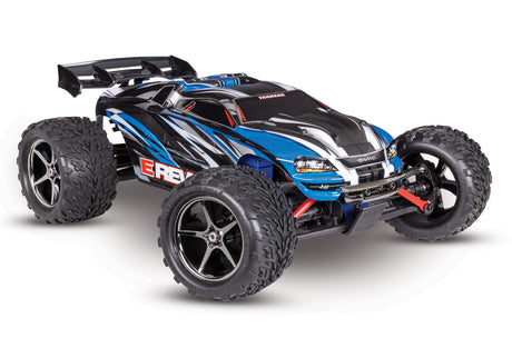 Blue Traxxas 1/16 E-Revo 4X4 RC car shown from a three-quarter low angle, highlighting its detailed design and rugged construction.