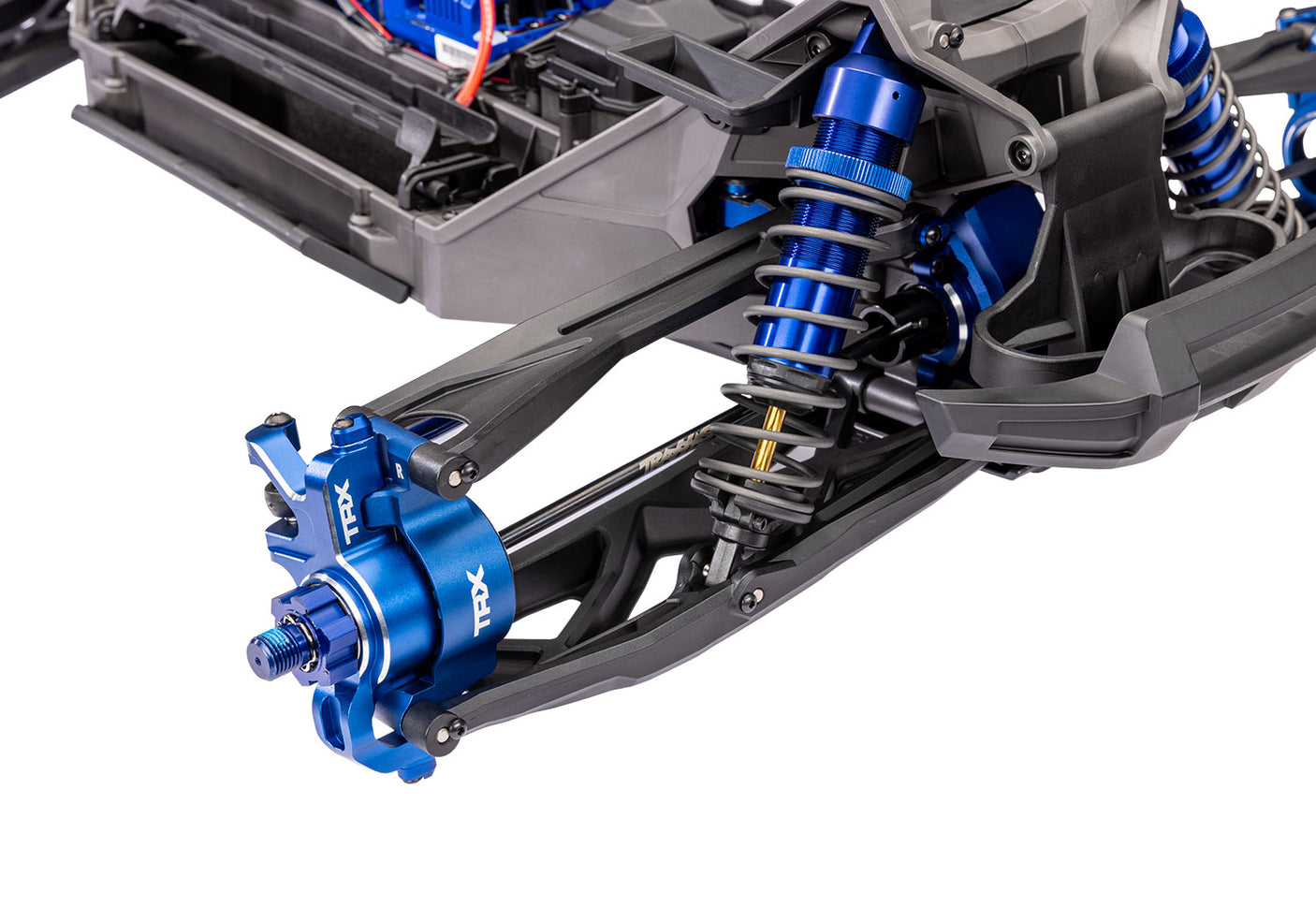 Traxxas X-Maxx Ultimate remote control monster truck front suspension with detailed shock absorbers and durable chassis.