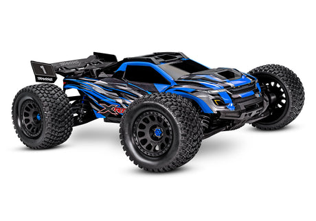 Orange Traxxas XRT 8S remote-controlled monster truck with large tires and detailed body, viewed from a three-quarter front angle.