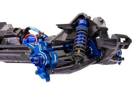 Traxxas XRT Ultimate remote control truck with half-front suspension and detailed chassis in black and orange.