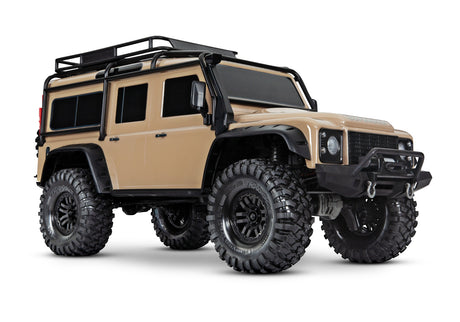 Traxxas TRX-4 Land Rover Defender RC truck in sand color, front three-quarter view showing detailed exterior and rugged design.