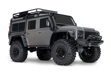 Traxxas TRX-4 Land Rover Defender RC model with silver exterior, front three-quarter view showing detailed rugged design.