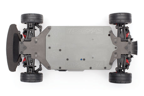 Traxxas 4-Tec 2.0 VXL chassis bottom view, showcasing the durable plastic construction and detailed design elements.