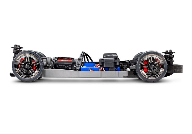 Side view of the Traxxas 4-Tec 2.0 BL-2s RC car chassis, showcasing its sleek black construction and detailed design.