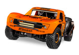 Traxxas Unlimited Desert Racer remote control car with orange body, front view showing sleek design and detailed exterior.