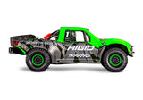 Traxxas Unlimited Desert Racer RC truck with green side panels and rugged off-road tires, shown from a side view.