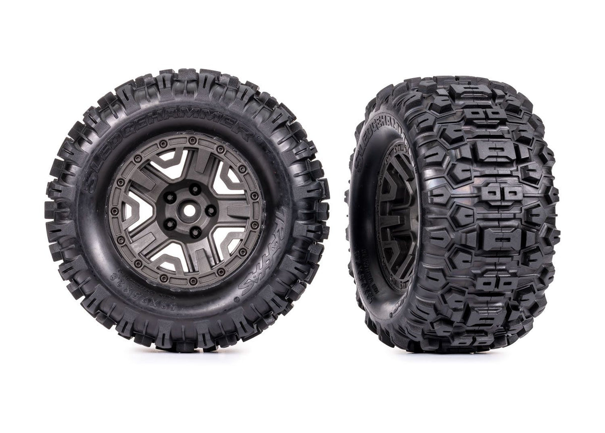 Traxxas 2.8-inch gray wheels with Sledgehammer tires for RC trucks, showing the wheel and tire details on a neutral background.