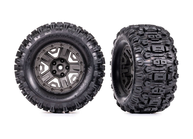 Traxxas 2.8-inch gray wheels with Sledgehammer tires for RC trucks, showing the wheel and tire details on a neutral background.