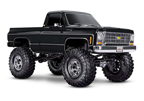 Traxxas TRX-4 Chevrolet K10 High Trail Edition RC truck with black front grille and detailed exterior, showcasing off-road design.