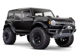 Traxxas TRX-4 2021 Ford Bronco 4x4 RTR crawler with detailed front view and black body, showcasing off-road tires and rugged design.