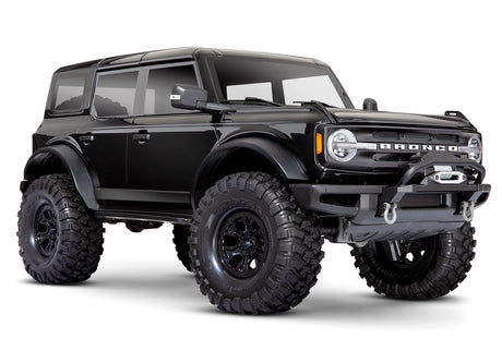 Traxxas TRX-4 2021 Ford Bronco 4x4 RTR crawler with detailed front view and black body, showcasing off-road tires and rugged design.