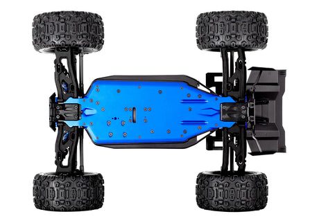 Traxxas 1/8 Sledge belt-driven RC truck chassis bottom view showing suspension and drivetrain components.