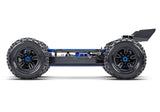 Side view of the Traxxas 1/8 Sledge belted RC truck chassis, showcasing the durable belt drive system and rugged construction.