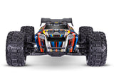 Traxxas 1/8 Sledge belted RC truck with blue body, front view showing rugged tires and detailed chassis.