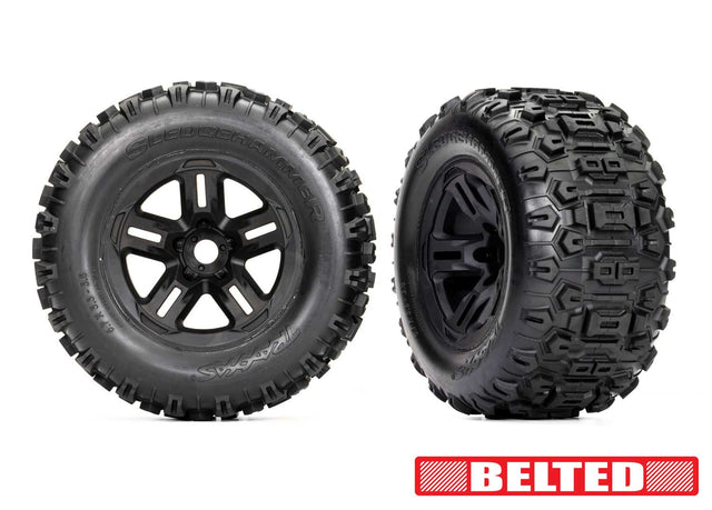 Traxxas 3.8-inch black wheels with belted Sledgehammer tires for RC trucks, showing the tires mounted on the wheels.