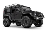 Traxxas TRX-4M Land Rover Defender RC scale model vehicle, front three-quarter view with detailed black exterior.