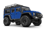 Traxxas TRX-4M Land Rover Defender remote control toy truck in blue, showing a three-quarter front view.