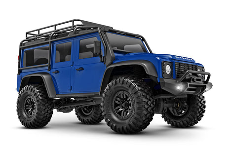 Traxxas TRX-4M Land Rover Defender remote control toy truck in blue, showing a three-quarter front view.
