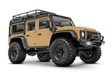 Traxxas TRX-4M Land Rover Defender remote control scale model vehicle, tan color, front three-quarter view.