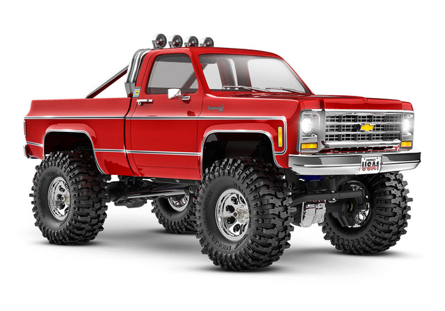Red Traxxas TRX-4M 1/18 scale Chevrolet K10 High Trail Edition RC truck with detailed front view and off-road features.
