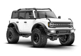 Traxxas TRX-4M Ford Bronco remote control car front quarter view showing white body and detailed design.