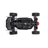 ARRMA 1/14 Typhon GROM 223S DSC 4x4 RTR brushless buggy on rough terrain, showing its sleek design and off-road tires.