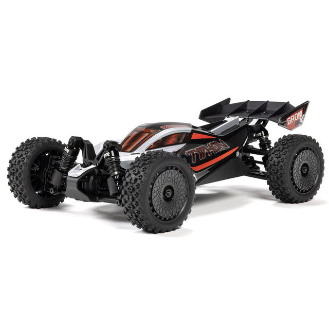 Silver ARRMA 1/14 Typhon GROM 223S DSC 4x4 RTR brushless buggy on off-road track, showcasing detailed design and rugged tires.