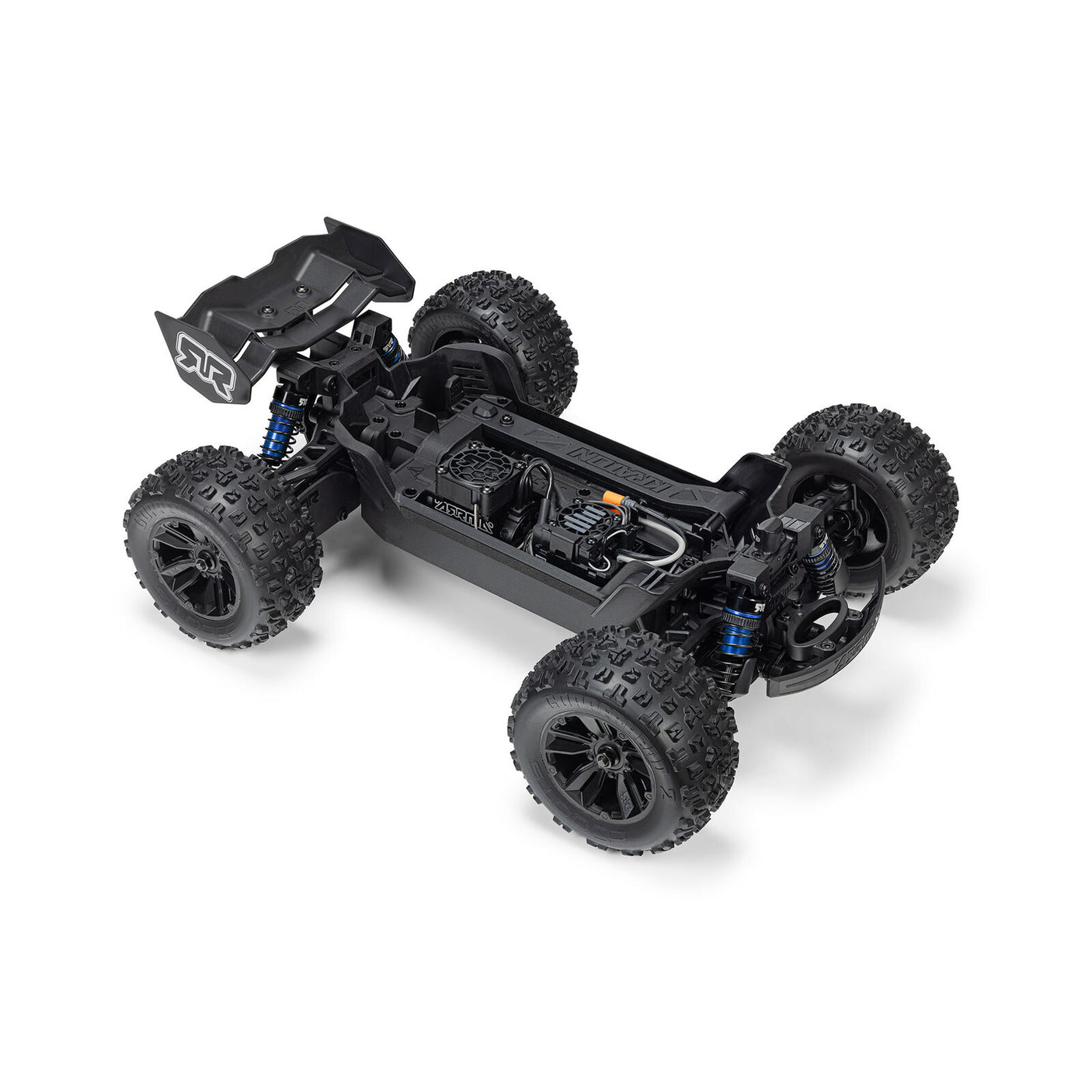 ARRMA 1/16 Mini Kraton 3S RC truck with charger and battery, showcasing the detailed miniature off-road vehicle on a display surface.