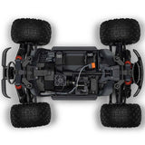 ARRMA 1/10 scale Granite 4x4 RTR brushed monster truck with rugged tires and vibrant orange and black body on off-road terrain
