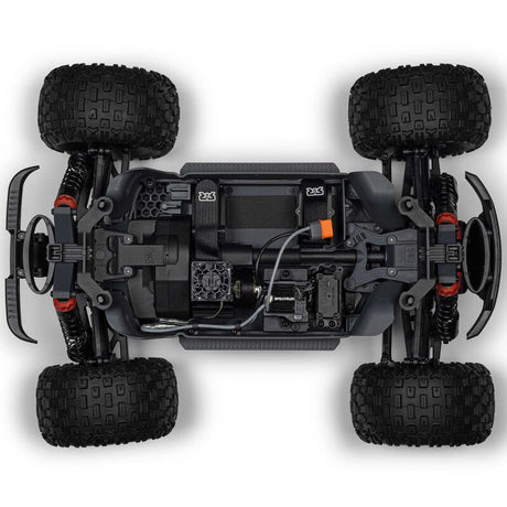 ARRMA 1/10 scale Granite 4x4 RTR brushed monster truck with rugged tires and vibrant orange and black body on off-road terrain