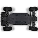 ARRMA 1/8 scale Typhon 4x4 RTR brushed buggy shown on a dirt track with vibrant orange and black body and large off-road tires.