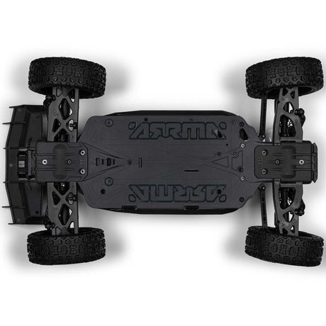 ARRMA 1/8 scale Typhon 4x4 RTR brushed buggy shown on a dirt track with vibrant orange and black body and large off-road tires.