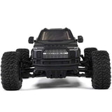 ARRMA 1/10 Big Rock 223S DSC 4x4 RTR brushless monster truck on rugged terrain, showcasing its off-road design and powerful build.