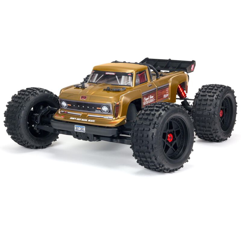 ARRMA Outcast 4X4 4S 1/10th scale 4WD stunt truck shown on rugged terrain with colorful body and large off-road tires.