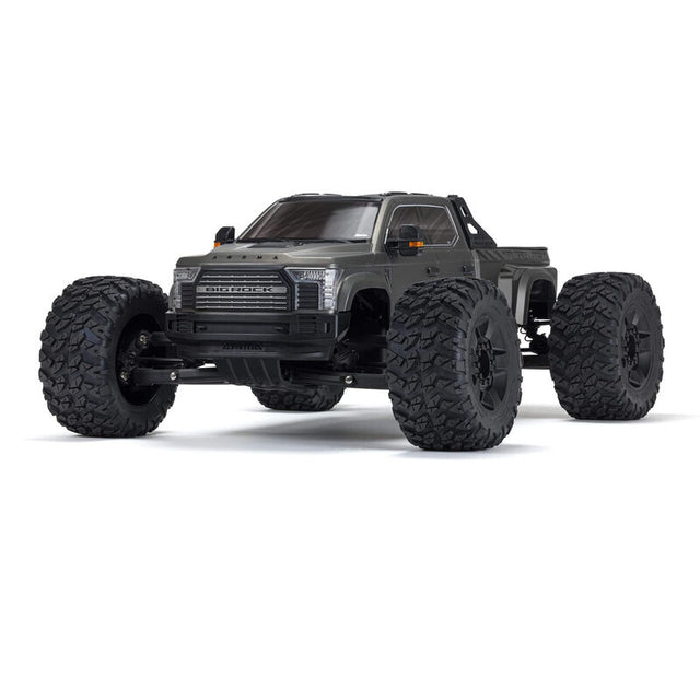 ARRMA 1/7 Big Rock 6S 4WD BLX RTR monster truck shown on rugged terrain with large tires and powerful suspension.
