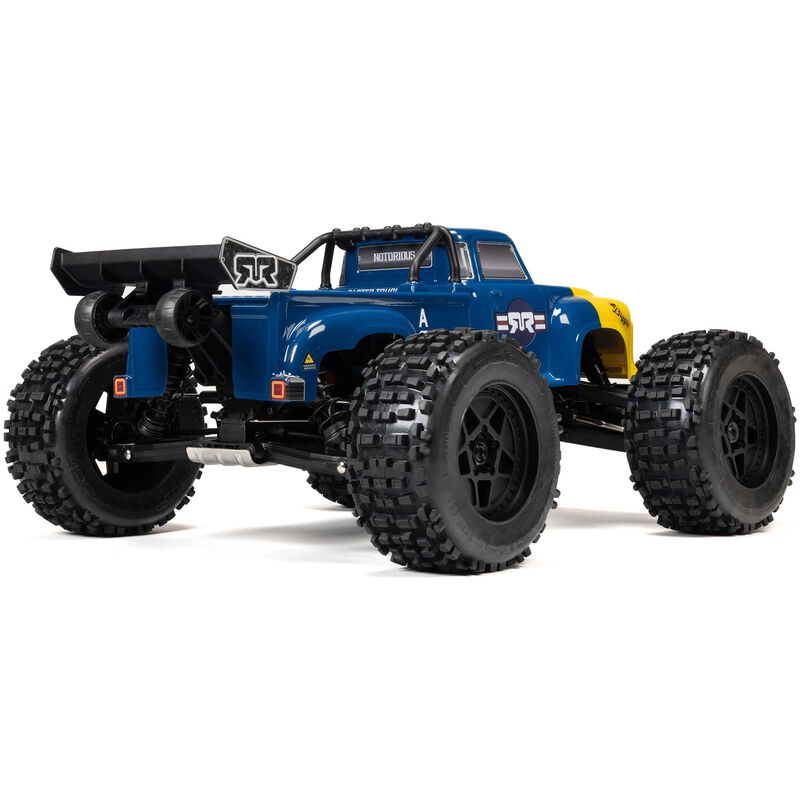 ARRMA 1/8 Notorious 4X4 6S BLX Brushless V6 stunt truck on rugged terrain, showcasing its powerful design and off-road capabilities.