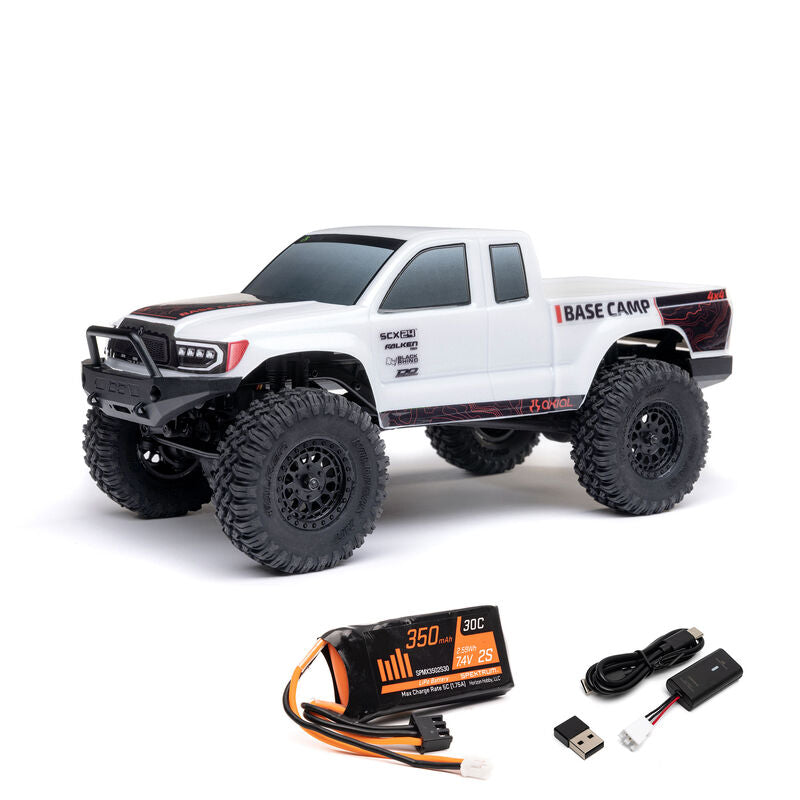 Axial 1/24 SCX24 Base Camp 4x4 RTR brushed rock crawler on rugged terrain with detailed chassis and tires.