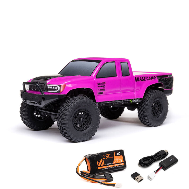 Axial 1/24 SCX24 Base Camp 4x4 RTR brushed rock crawler on rugged terrain with detailed body and off-road tires.