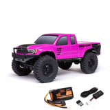 Axial 1/24 SCX24 Base Camp 4x4 RTR brushed rock crawler on rugged terrain with detailed body and off-road tires.