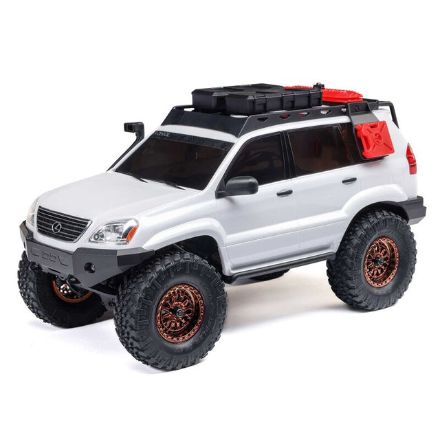 Axial 1/24 scale SCX24 Lexus GX 470 4x4 brushed rock crawler on rugged terrain with detailed exterior features.