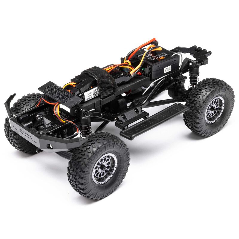 Axial 1/24 Lexus GX 470 4X4 RC rock crawler with brushed motor, detailed scale model on rugged terrain, ready for off-road adventures.