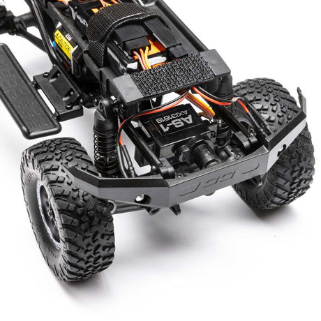 Axial 1/24 SCX24 Lexus GX 470 4x4 RTR brushed rock crawler on rough terrain, showcasing detailed exterior and rugged tires.