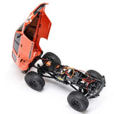Axial 1/24 SCX24 Toyota 4Runner 4x4 brushed rock crawler RC vehicle on rugged terrain