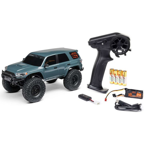 Axial 1/24 SCX24 Toyota 4Runner 4X4 RTR brushed rock crawler on rocky terrain with detailed exterior and rugged tires.