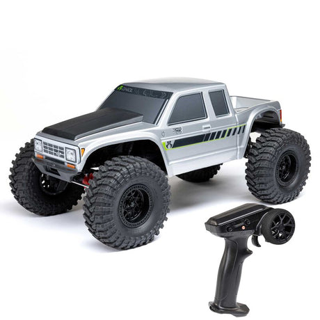 Axial 1/10 SCX10 III Coyote 4x4 RTR brushed rock crawler with detailed chassis, tires, and RC body in rugged off-road setting