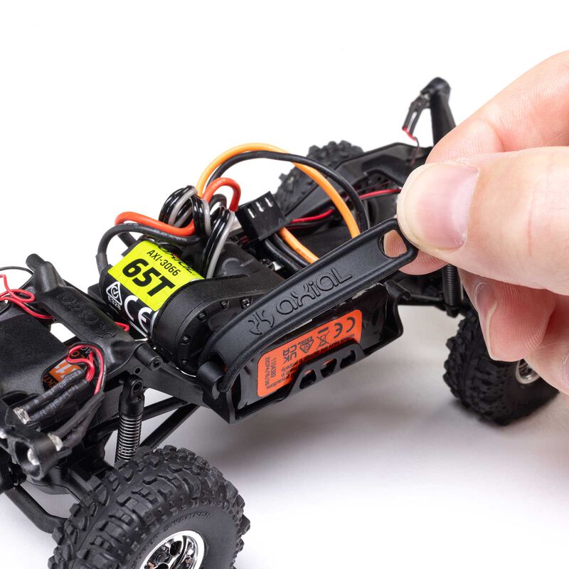 Axial 1/30 scale SCX30 Chevrolet K10 4x4 RTR brushed rock crawler on rugged terrain with detailed body and off-road tires.